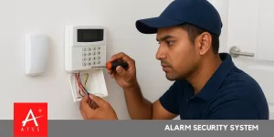Technician installing an alarm security system in a Chennai home